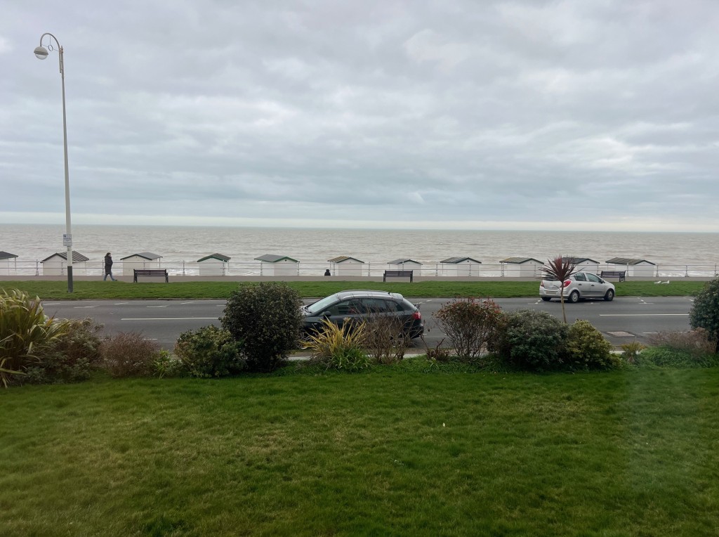 Lot: 115 - GROUND FLOOR FLAT - View of road and seafront from outside the front of the building